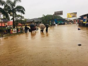 People Wade Through the Flood Waters